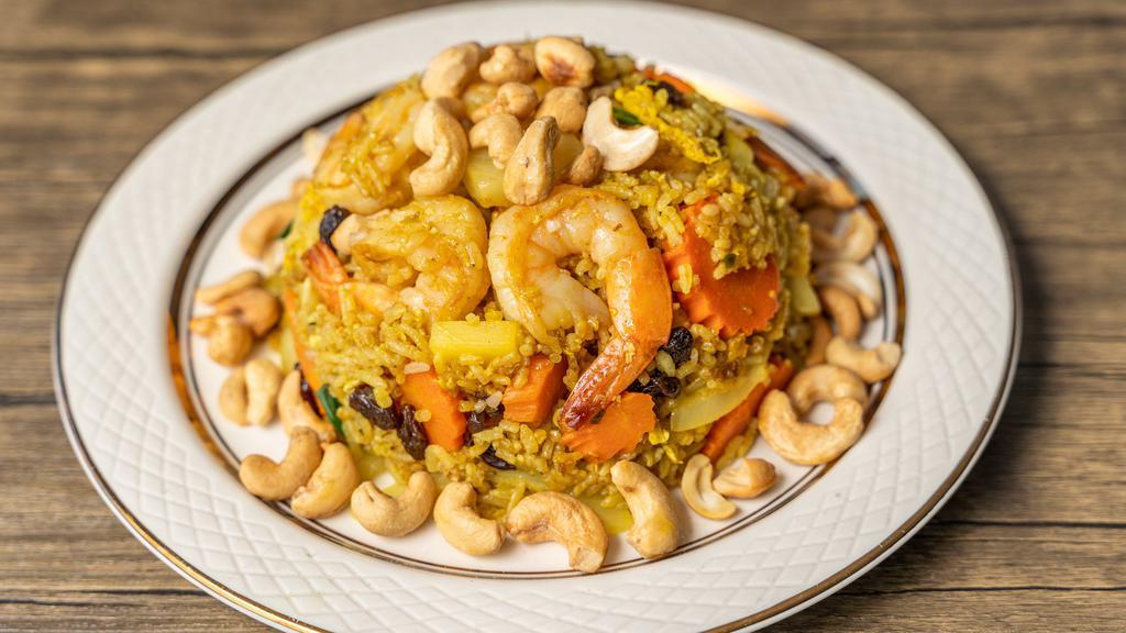 Shrimp Pineapple Fried Rice · Stir fried rice, pineapple, shrimps, raisins, cashews, raisins, carrots, onions, and green onions in house sauce.