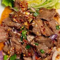 Flank Steak Waterfall · Isanneau nam tok, sliced grilled tender beef mixed with, onions, rice powder, chili, mint le...