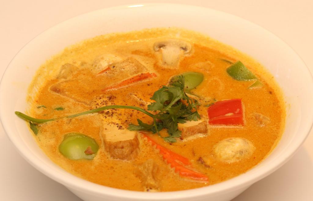 Vegetarian Curry Soup · Vegetarian curry soup with Tofu, potatoes, sweet potatoes, bell peppers, mushrooms, carrots served with white rice.
