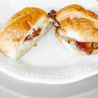 Brie-Ing Down The House · Sliced roasted turkey, bacon, brie cheese, pepper jelly, mayo on a toasted croissant.