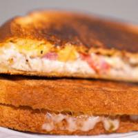 The Hawaiian Melt · Melted Monterey Jack & mozzarella, sliced ham, and pineapple pressed on sweet Hawaiian bread