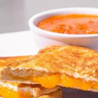 Grilled Cheese & Tomato Soup · Cup of our delicious home made chunky, creamy tomato soup with a grilled cheese sandwich on ...