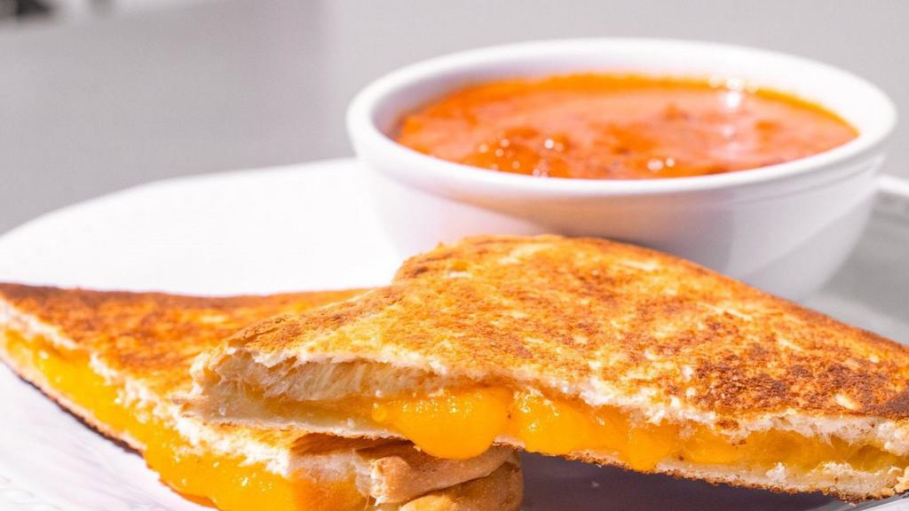 Grilled Cheese & Tomato Soup · Cup of our delicious home made chunky, creamy tomato soup with a grilled cheese sandwich on sourdough.