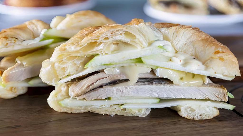 The Mason Sandwich · Sliced turkey breast, melted brie cheese, thinly sliced apples, and a mild honey mustard sauce on a toasted croissant.