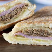 The Tampa Sandwich · Braised mojo pork, sweet ham, dill pickles, mustard, mayonnaise and Swiss hot pressed on a h...
