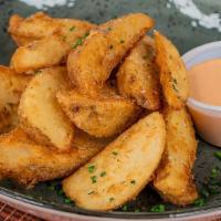Potato Wedges · Delicious crispy wedges with house ranch