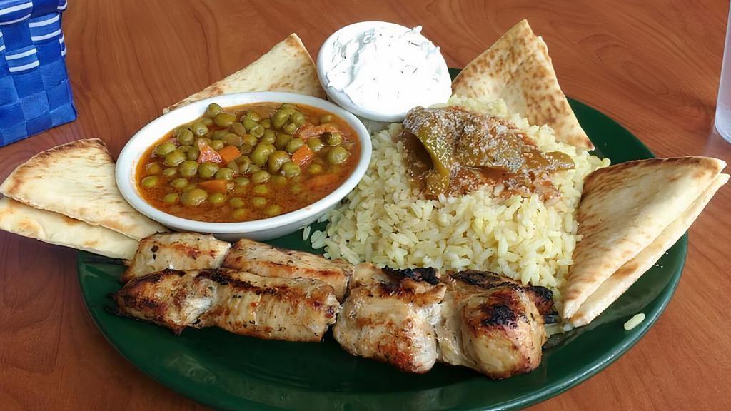 Chicken Souvlaki · Marinated and skewered boneless skinless chicken breast. Served with rice, yia yia’s veggies, and pita.