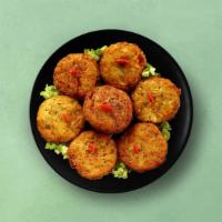 Spiced Potato Patty · Golden fried-potato patty stuffed with peas and served with a spicy relish.
