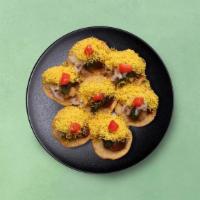 Wheat Crisps Chaat · Crushed wheat wafers mixed with potatoes, cucumbers, tomato, and onion. Topped with tamarind...