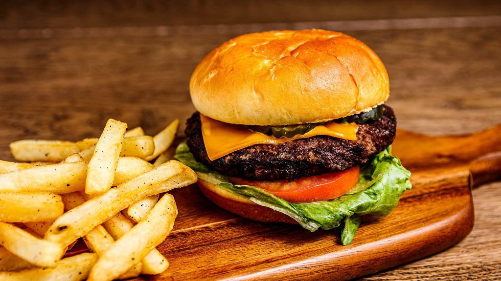 Main Land Burger · Grilled beef patty, American, tomato, lettuce, and pickle served on a toasted bun served with a side of fries.
