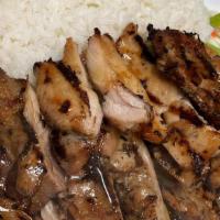 House Chicken · Grilled chicken thigh marinated in soy based sauce served over a bed of rice and side salad.