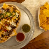 Nachos · A choice of meat, beans, salsa, with a variety of condiments, served on bed of corn chips, t...