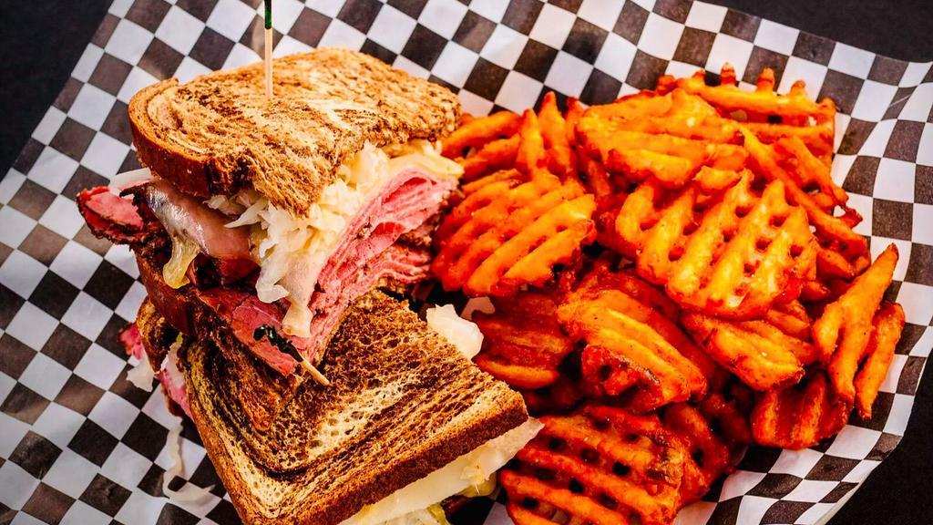 Reuben Sandwich · Thinly sliced pastrami, melted Swiss cheese, sauerkraut, Russian dressing between slices of marble rye bread, and served with your choice of side.