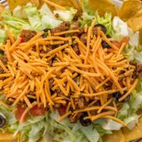 Taco Salad · Mixed greens topped with seasoned ground beef, Cheddar cheese, tomatoes, and black olives an...