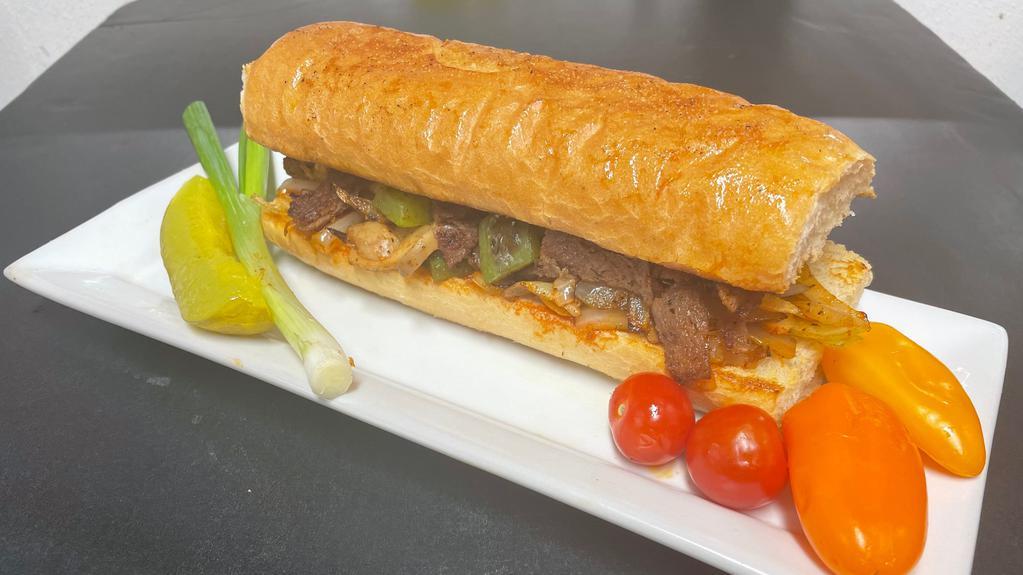 Philly Cheese Steak (Sandwich) · Philly cheese steak sandwich served with Grilled onion, bell peppers, mushrooms and Swiss cheese.