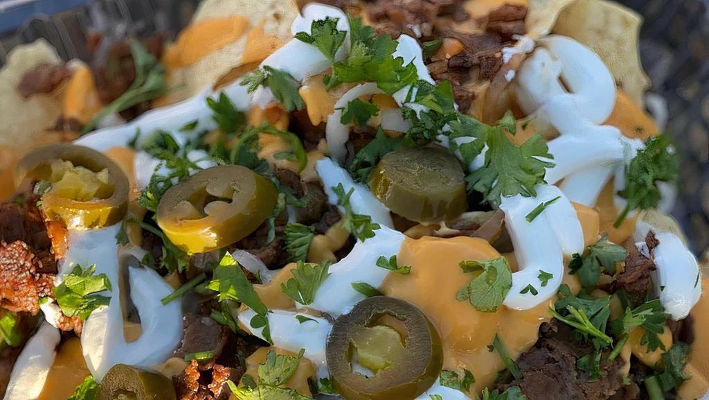 Cheese Steak Over Nachos · Steak Philly grilled with onion, bell peppers and mushrooms served on top of Nachos and cheese wiz and jalapeño on top.