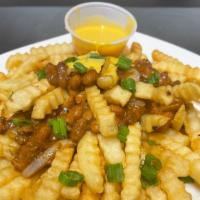 Chili Cheese Fries · Large fries with meat and beans chili and cheese wiz on top.