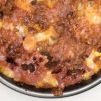 The Hunter’S Pizza · Bacon, Ham, Pepperoni, Sausage, and extra cheese are piled high on top of a freshly prepared...