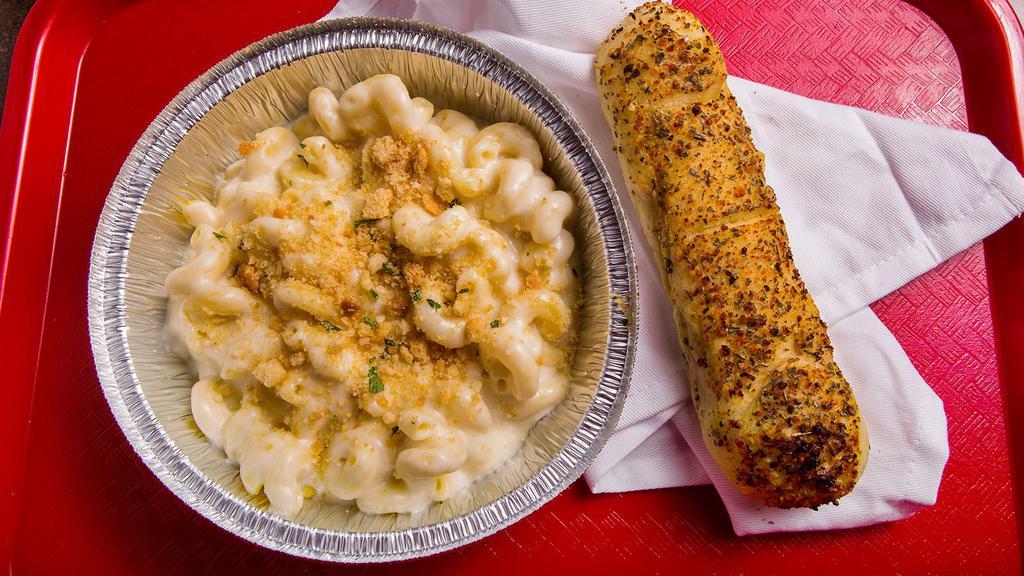 Mac N Cheese · Large portion of white cheddar Mac n Cheese. We put breadcrumbs and extra cheese on top upon request. Comes with a breadstick!