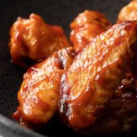 Bbq Wings · Wings tossed in a classic and smokey BBQ sauce.