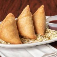 Samosa · Pastry stuffed with mildly spiced potatoes and peas.