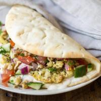 Cauliflower Wrap · Fried Cauliflower served with Hummus, Tahini, Lettuce, Tomatoes, Cucumber, Onions & wrapped ...