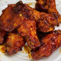 Thai Hot Wings · 7 pieces of chicken wings tossed in spicy ThaiDash's Hot Wings Sauce. Sauce contains Srirach...