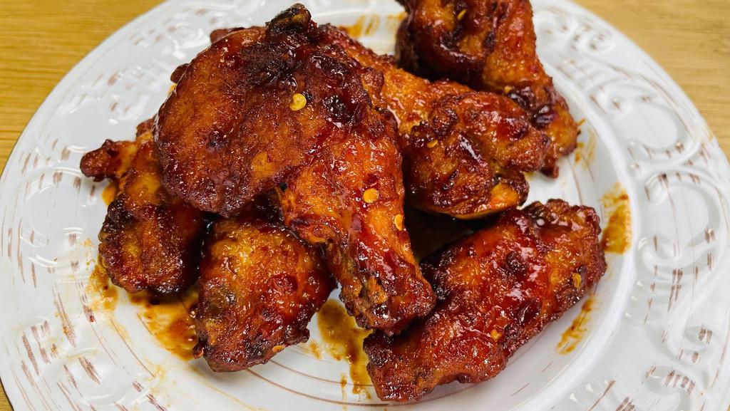 Thai Hot Wings · 7 pieces of chicken wings tossed in spicy ThaiDash's Hot Wings Sauce. Sauce contains Sriracha, Ketchup, soy sauce, and chili flakes.
