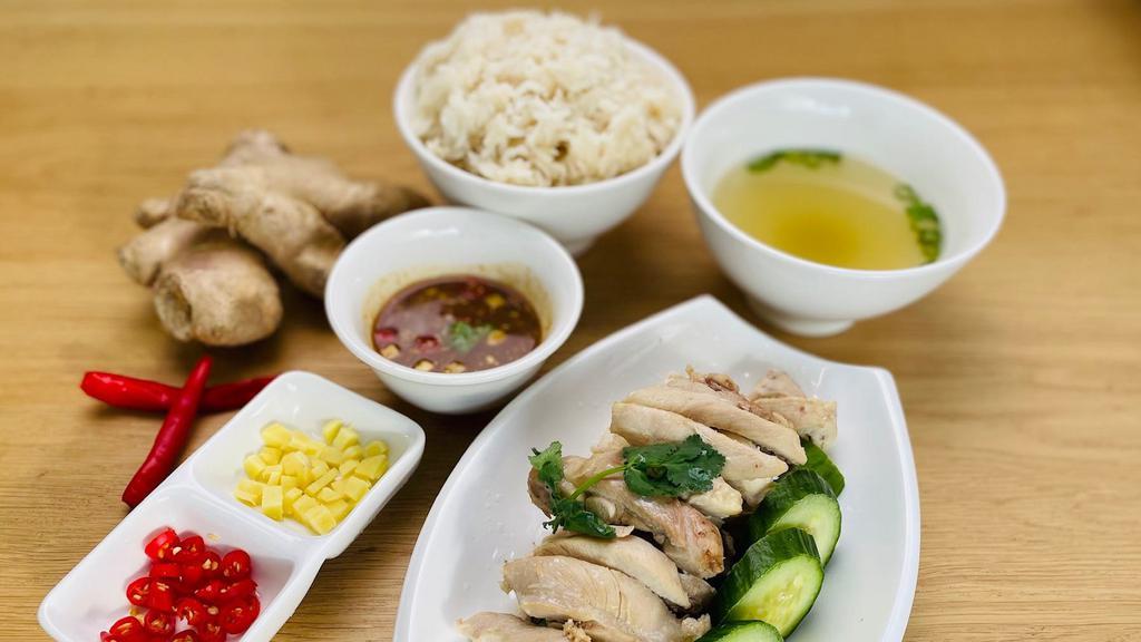Khao Mun Gai · Thai variation of Hainanese chicken rice, a dish that extremely popular throughout Southeast Asia. Soft and tender chicken, with the most flavorful rice served with cucumber and Thai style chicken sauce. This dish is all about the sauce. Served with 8oz soup.