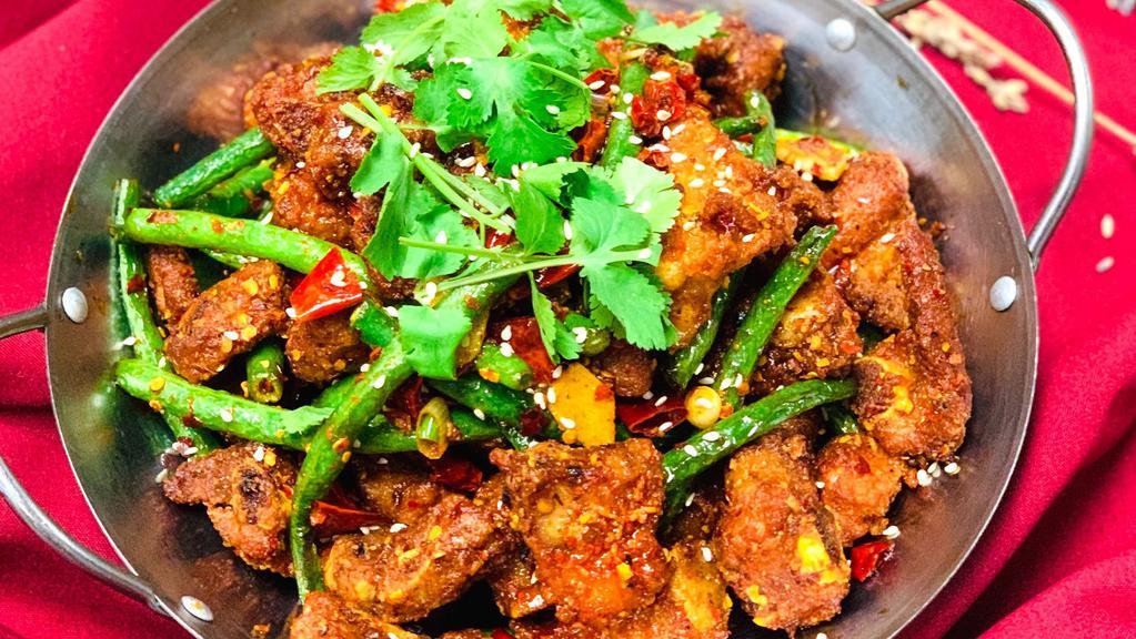 Hot & Spicy Spareribs On Hot Griddle / 秘制干锅排骨 · Marinated pork ribs, bell peppers, onion, potatoes, chef's hot and spicy seasoning.