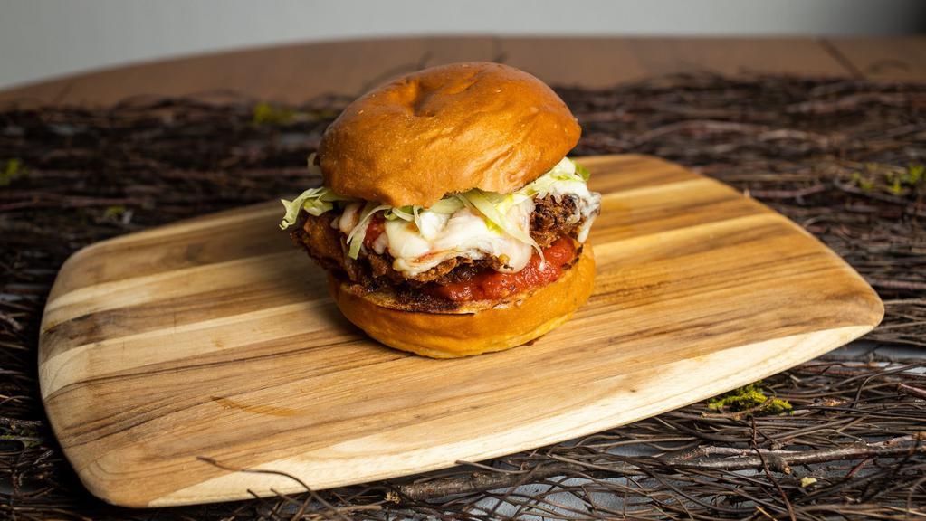 Fried Chicken Parm Sandwich · Best of the barnyard - chicken parmesan sandwich topped with mozzarella cheese and marinara sauce.