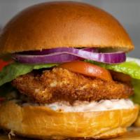 Classic Cluckery Fried Chicken Sandwich · Dish out on crispy fried chicken with caper aioli, lettuce, and tomato. Add some fries to co...