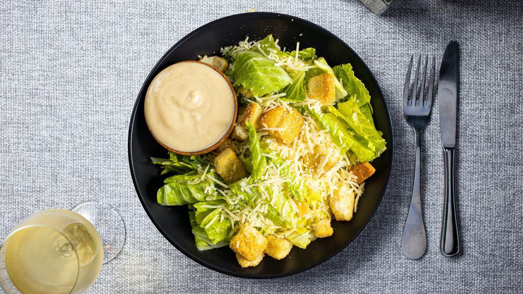 The Caesar Salad  · Romaine lettuce, house croutons, and parmesan cheese with Caesar dressing