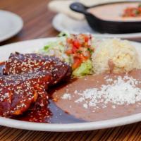 Palenque Mole · Bone-in roasted chicken drenched in mole sauce, served with house-made refried beans, rice, ...