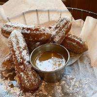 Churros · Chocolate filled churros, sprinkled with cinnamon & powdered sugar. Served with dulce de lec...