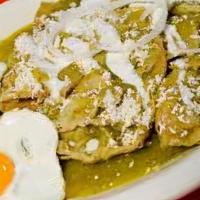 Chilaquiles Con Huevos · Fried corn tortillas simmered in habanero hot salsa Verde, topped with two fried eggs, your ...
