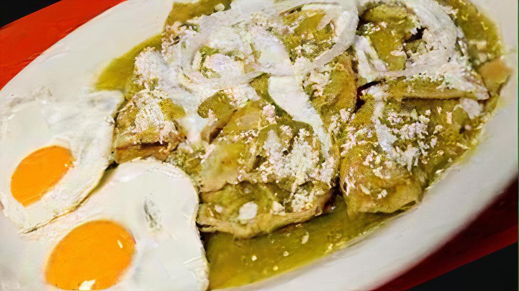 Chilaquiles Con Huevos · Fried corn tortillas simmered in habanero hot salsa Verde, topped with two fried eggs, your favorite choice of meat, cilantro, onions, sour cream and queso fresco.