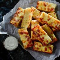 Deep Dish Bread · 12 pieces. Deep dish pizza dough freshly baked with premium mozzarella, topped with butter, ...