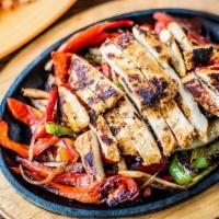 Fajitas · Grilled chicken, sautéed onions and peppers, guacamole, pico, sour cream, lettuce, cheese, c...