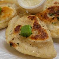 The Ruskie Pierogi (Potato & Cheese) · Our most traditional flavor, the Ruskie Pierogi is stuffed with fluffy potatoes and cheddar ...