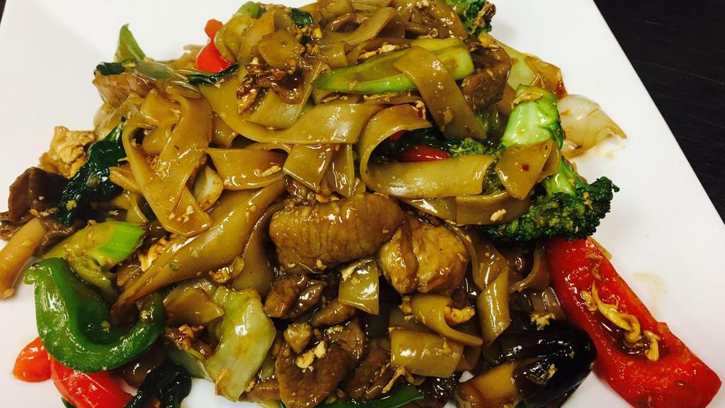 Phad Kee Mow (Drunken Noodles) · Flat rice noodles stir-fried with garlic, eggs, sweet basil, bell peppers, bok choy, broccoli, Chinese broccoli, mushrooms, and sweet soy sauce.