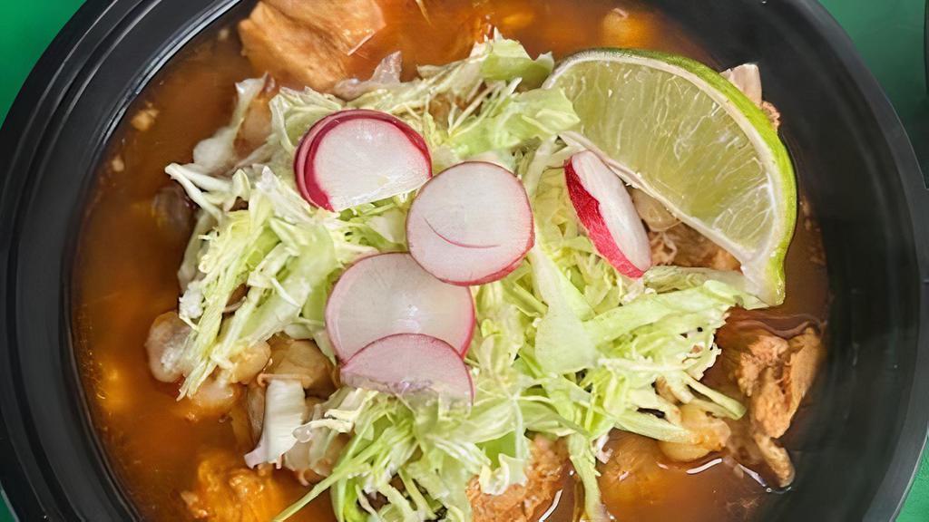 Pozole Rojo · Brothy soup made with pork, hominy and a mix of non-spicy red chiles. Topped with shredded lettuce, radish, onion and a slice of lime.