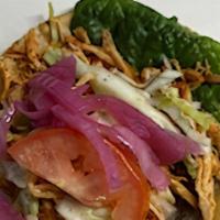 Panuchos · Corn tortillas stuffed with refried beans topped with your choice of protein and cabbage, le...