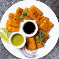 Paneer Pakoras · Lightly battered paneer fried until crispy on the outside and gooey on the inside.