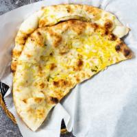 Garlic Naan · Leavened flatbread made from white flour, cooked until puffy and blistering, then coated in ...