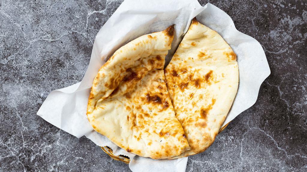 Naan · Leavened flatbread made from white flour and cooked until puffy and blistering.