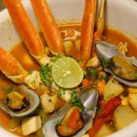 Seafood Molcajete · Delicious Mexican dish. Served on a warm rock plate called molcajete. With crab legs, fish, ...