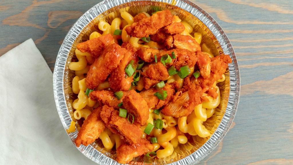Buffalo Mac · Cheddar Mac, Chopped fried chicken strips tossed in Buffalo Sauce, topped with chopped green onion and drizzled with Buffalo Sauce.