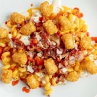 The Works · Cheddar Mac, Bacon, Sauteed Red Bell Peppers and Onions, topped with Tater Tots and Drizzled...
