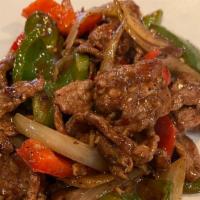 Pepper Steak · Stir-fried beef with black pepper, bell peppers, onions.